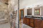 Massive walk-in shower with his and her sinks 
